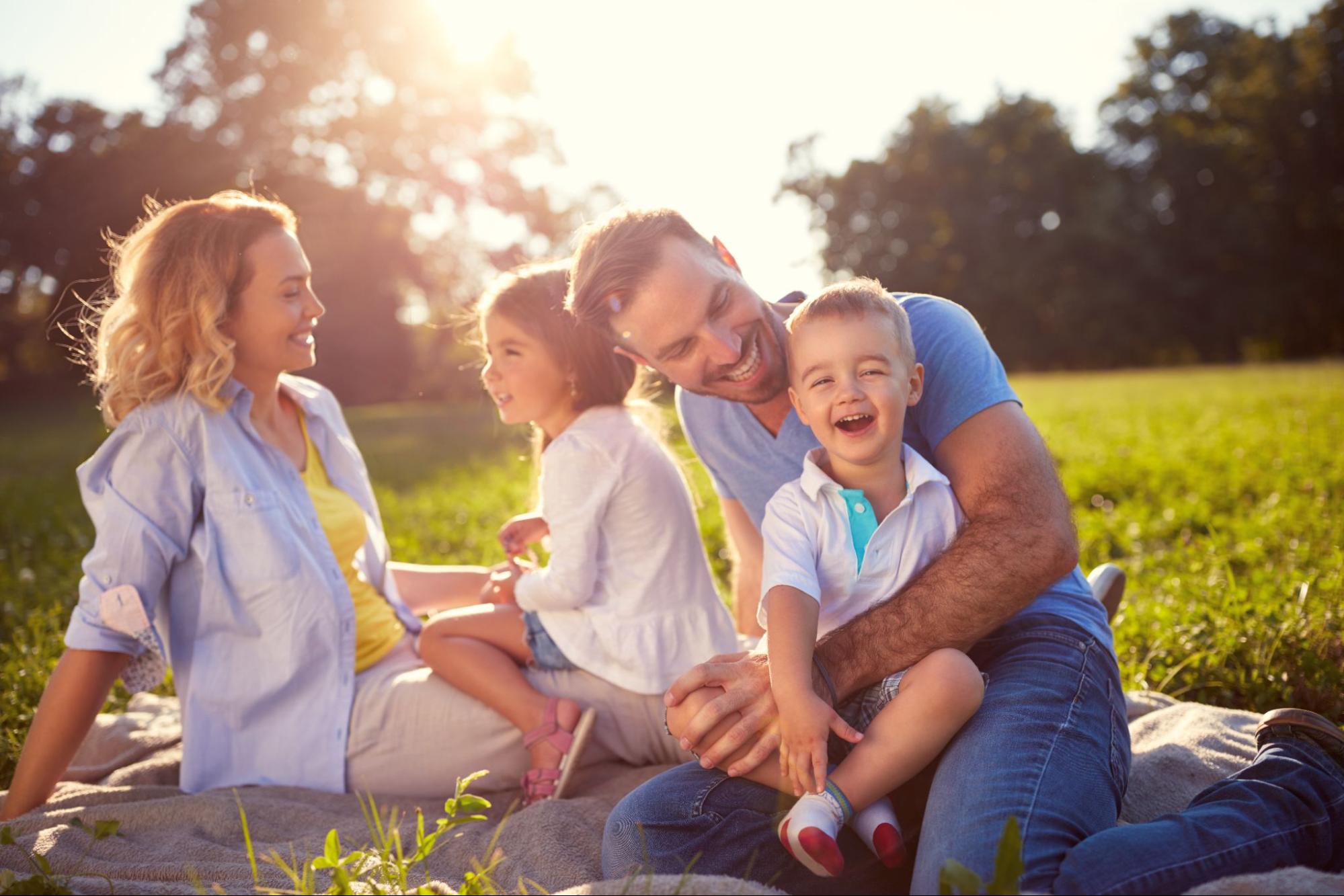 family hanging out in grass ©Lucky Business