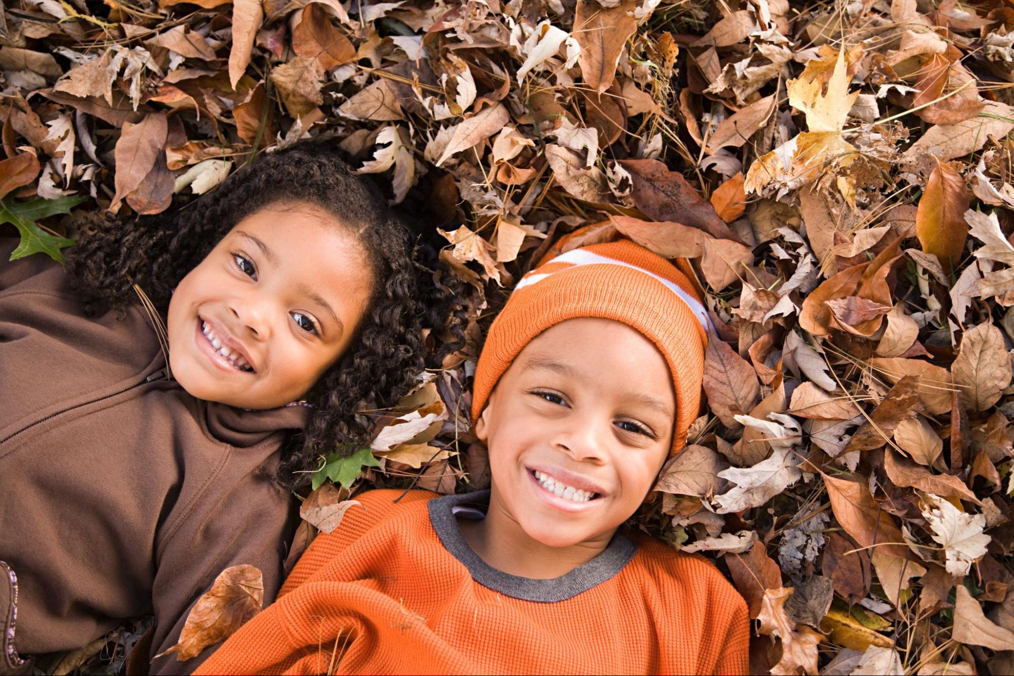 Children enjoying fall activities in McDonough GA, playing in autumn leaves © XiXinXing